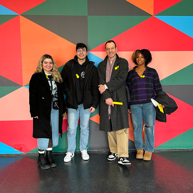 R3 people standing in front of colorful wall