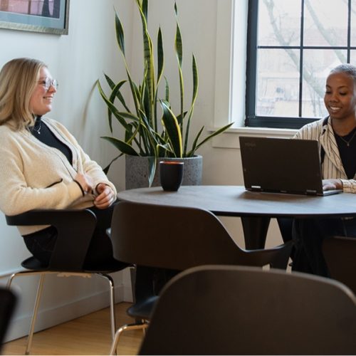 R3 employees talking and working at a kitchen table